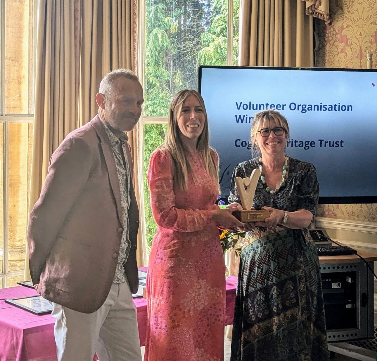 Cogges' team members and volunteer receiving the award